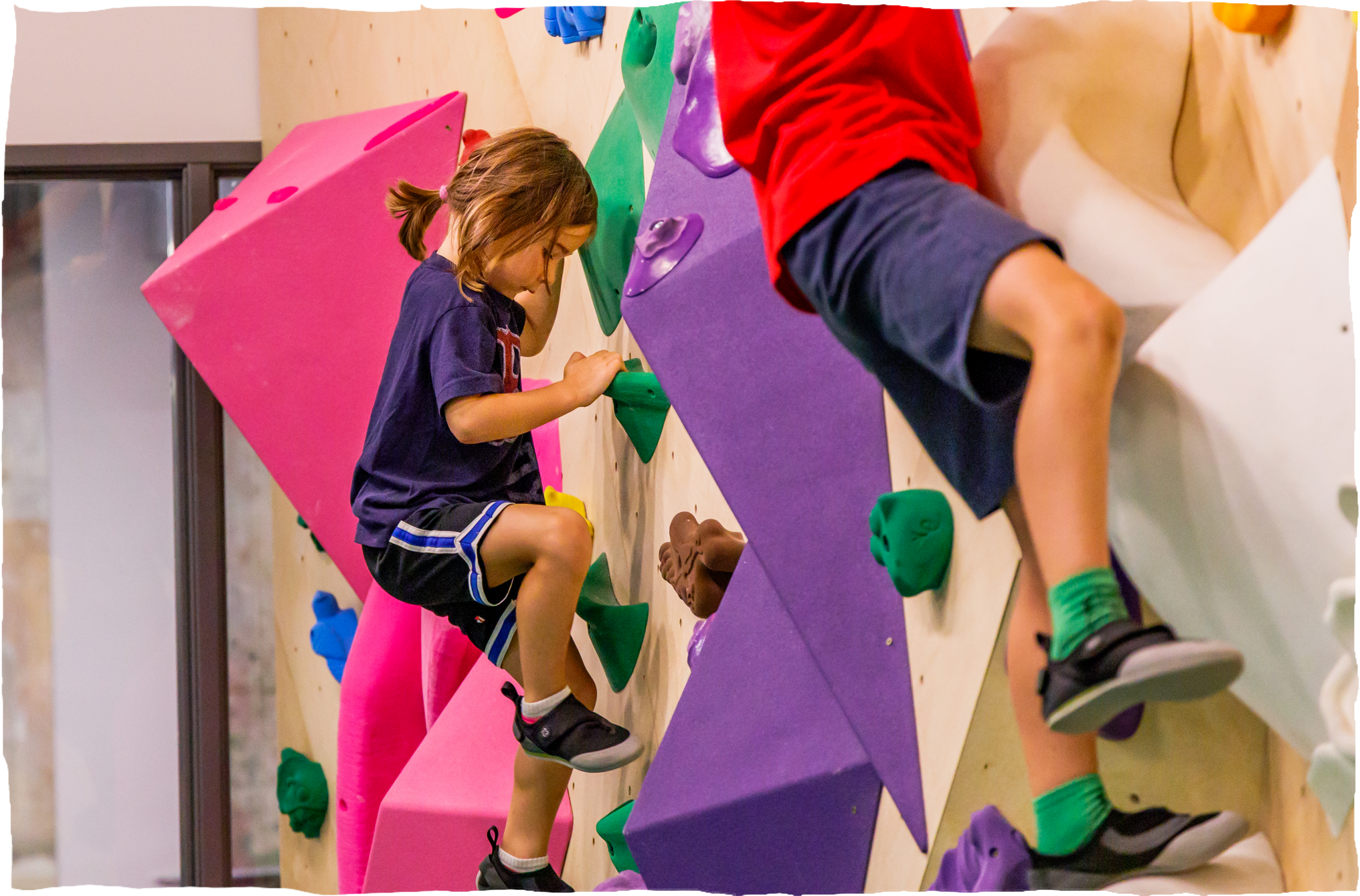 A girl and boy climbing at North Mass