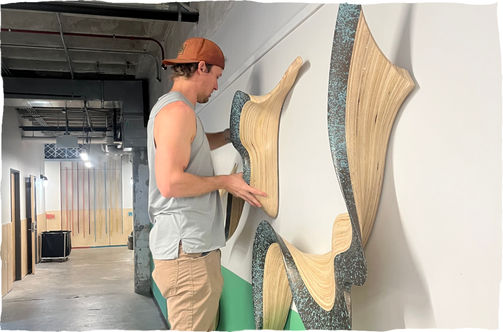 Artist at North Mass putting up work