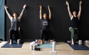 Three people doing yoga at North Mass
